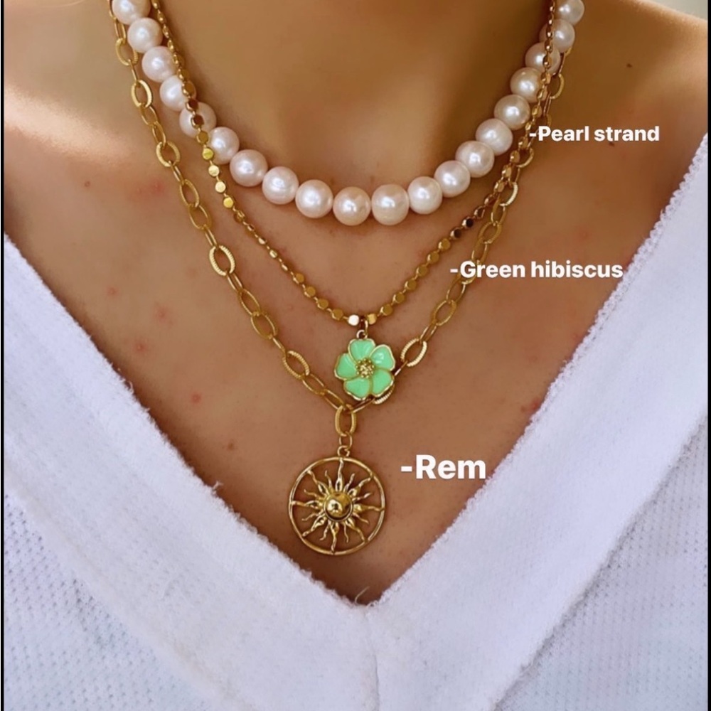 Logan Tay REM necklace. Gold sunburst design.